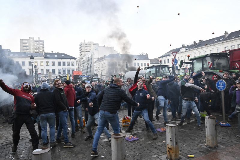  Protesting farmers hurl eggs and clog streets with tractors as EU summit begins